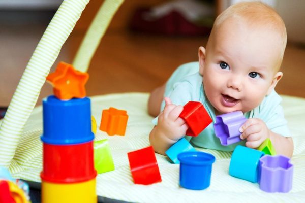 baby-playing-with-colorful-toys-home-happy-6-months-old-baby-child-playing-discovery