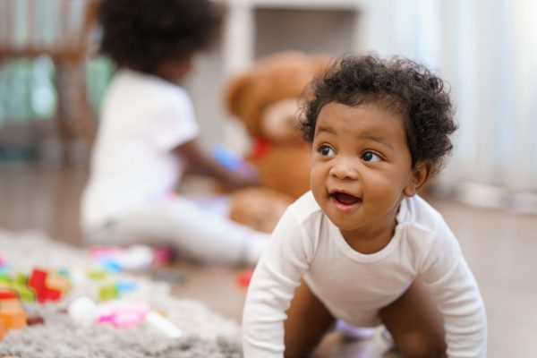 Happy African American Little baby boy crawling and looking for some thing to learn